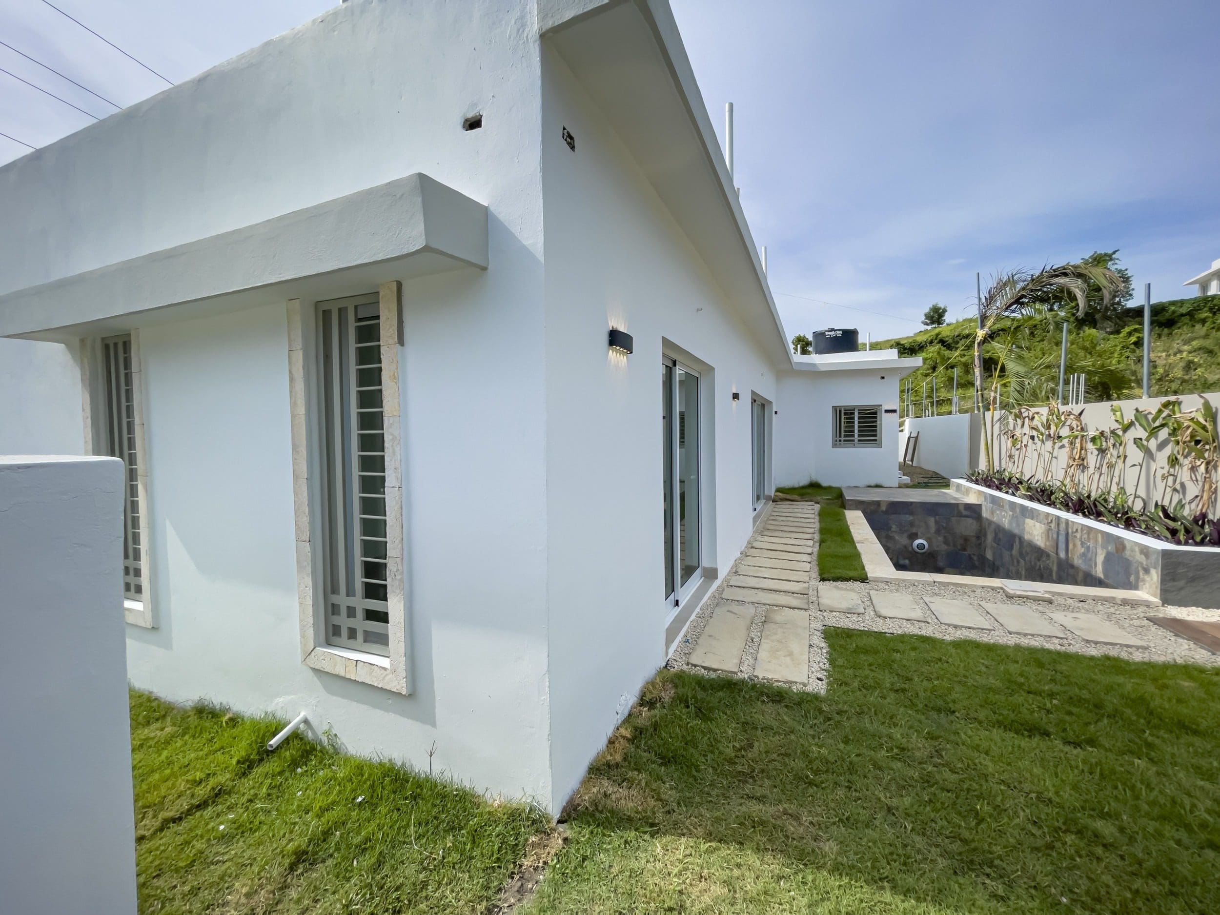buyDRproperty Modern villa for sale in Sosua Hills with a pool and lawn. Sosua Real Estate