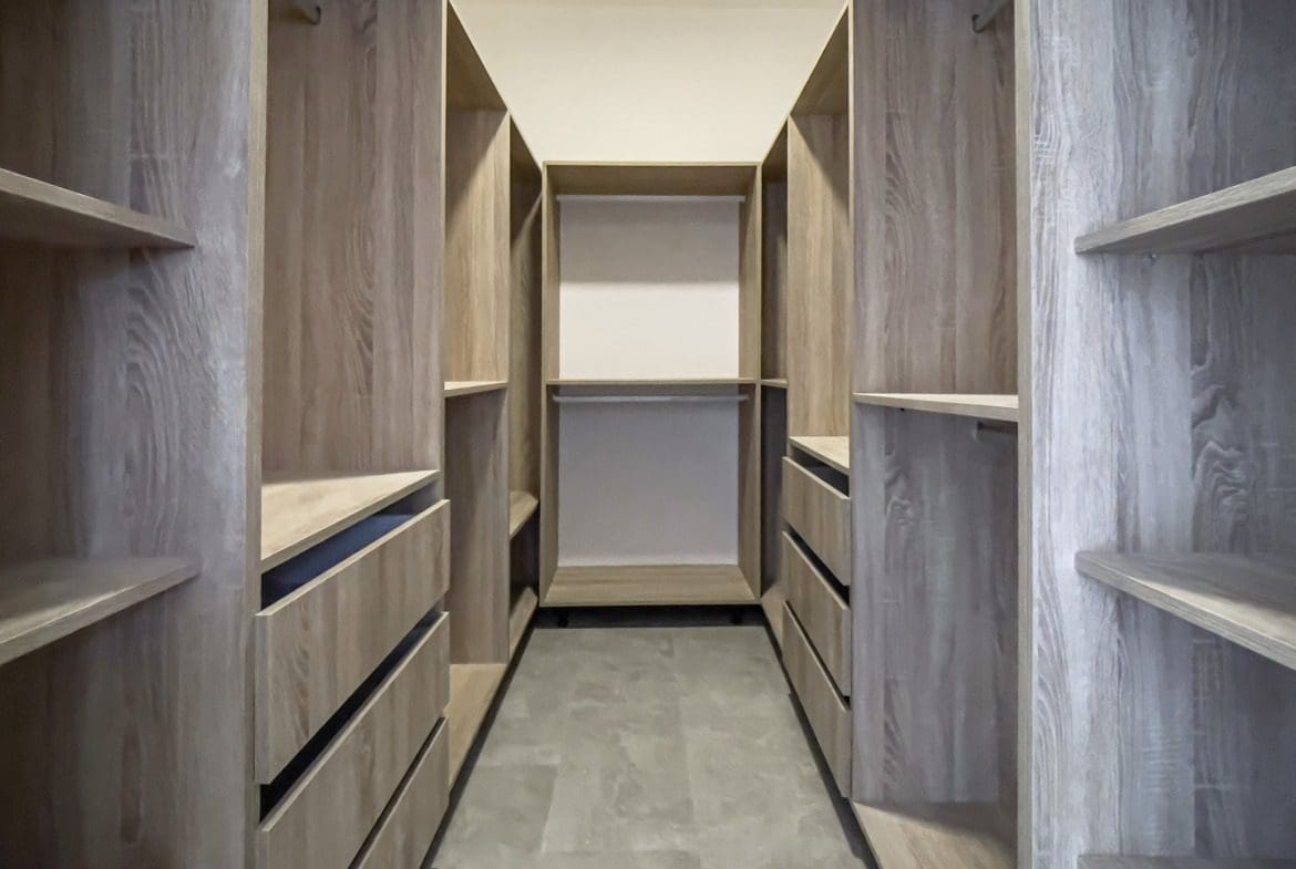 buyDRproperty Empty walk-in closet with wooden shelves and drawers. Villa for sale. Sosua Real Estate