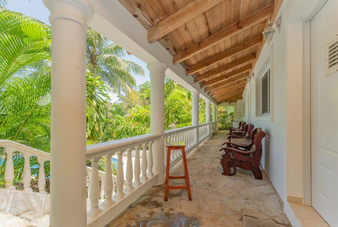 buyDRproperty Tropical villa balcony with lush green surroundings, Sosua, Hispaniola Residential. Sosua Real Estate