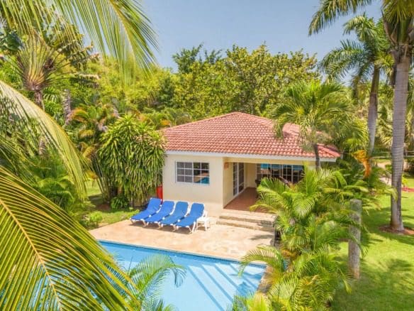 buyDRproperty Two Bedroom Villa Colibri for sale, with a pool and palm trees. Sosua Real Estate