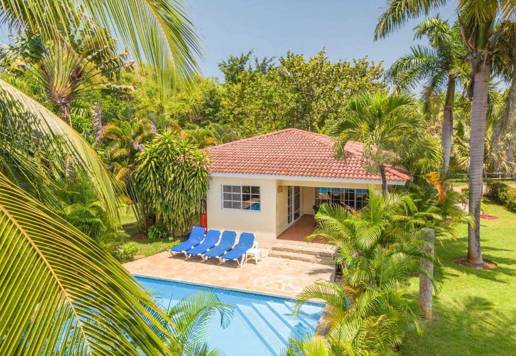 buyDRproperty Two Bedroom Villa Colibri for sale, with a pool and palm trees. Sosua Real Estate