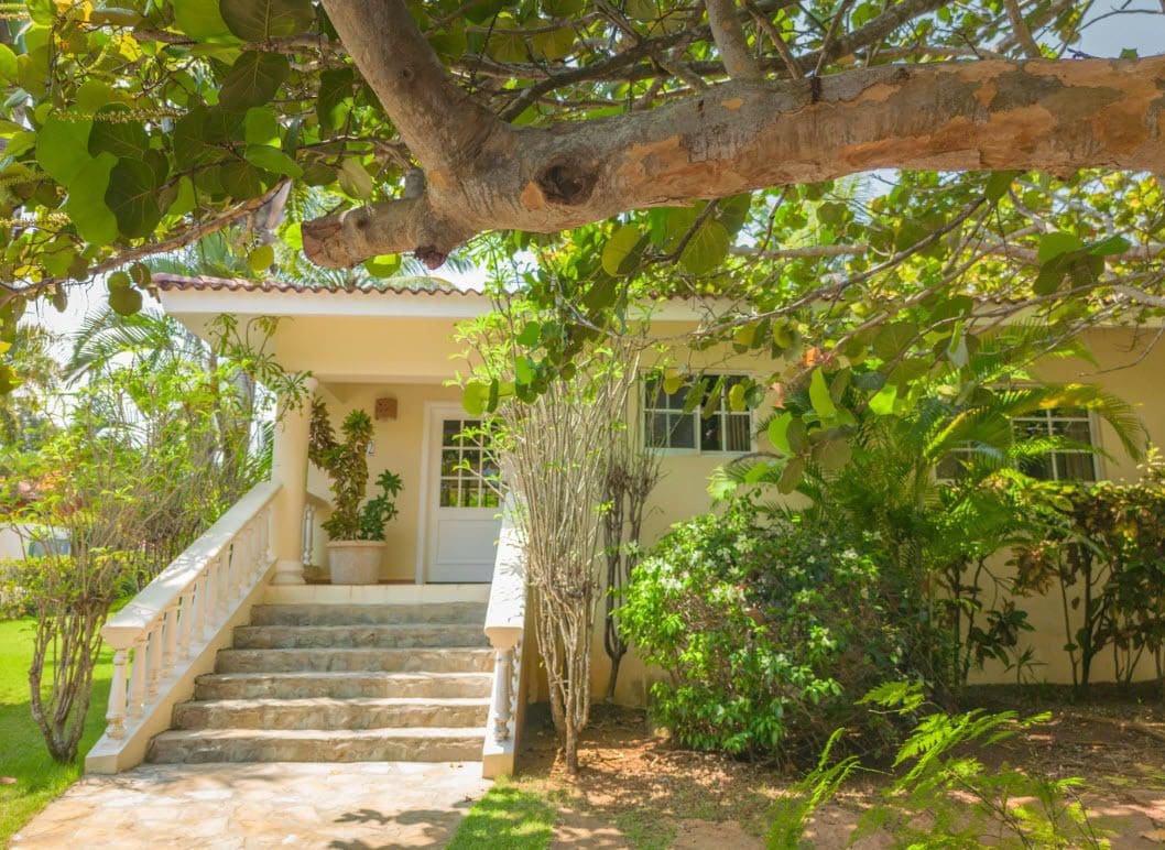 buyDRproperty Quaint two-bedroom villa Colibri with lush landscaping, steps to the front door. Sosua Real Estate