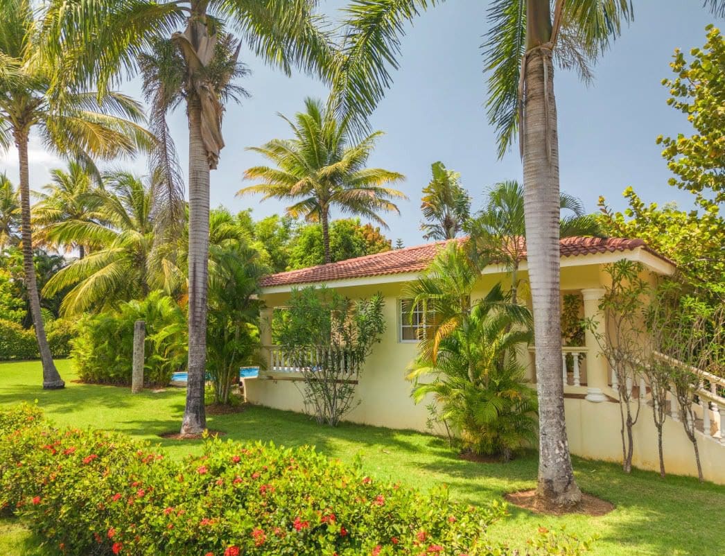 buyDRproperty Two Bedroom villa Colibri for sale surrounded by palm trees and lush greenery. Sosua Real Estate