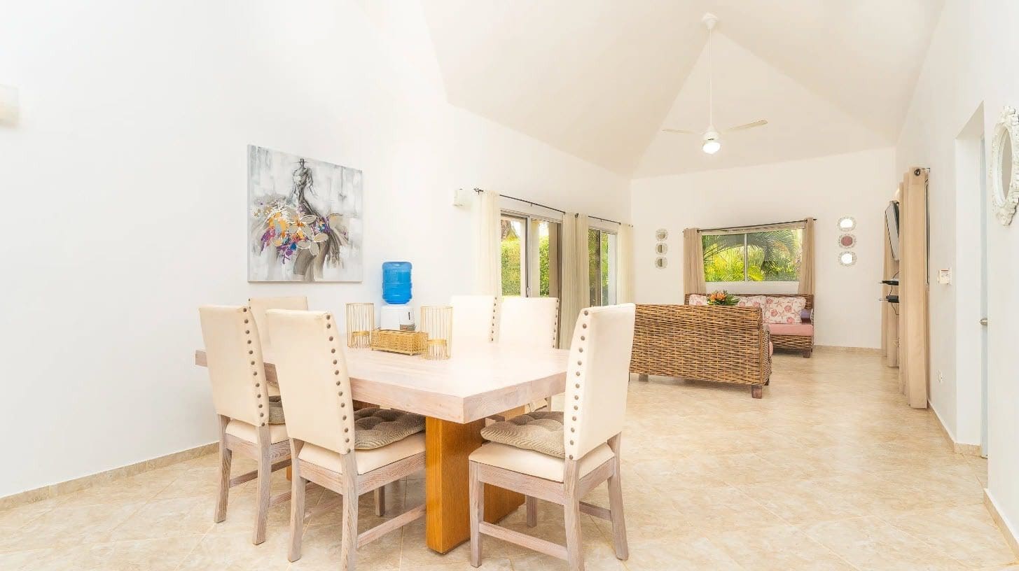 buyDRproperty Dining area in a beautiful villa for sale, featuring a table, chairs, and artwork. Sosua Real Estate