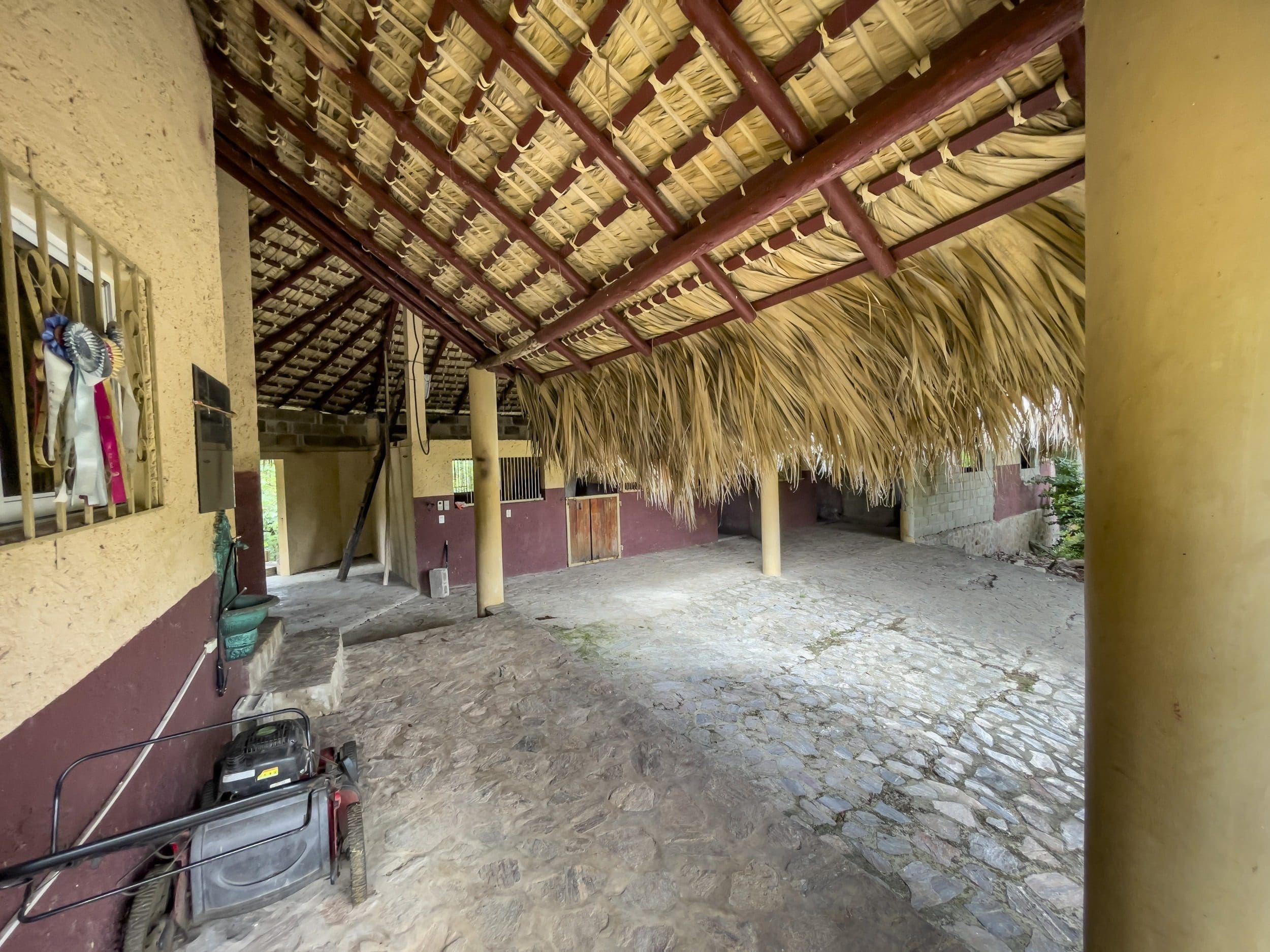 buyDRproperty Rustic building lot with thatched roof stables Sosua Real Estate