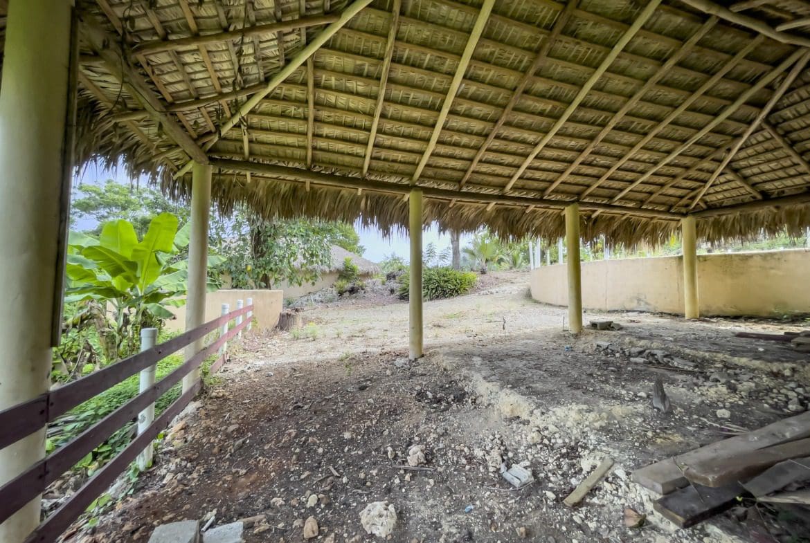 buyDRproperty Dilapidated structure with thatched roof. Building lot with dirt floor and fence. Sosua Real Estate