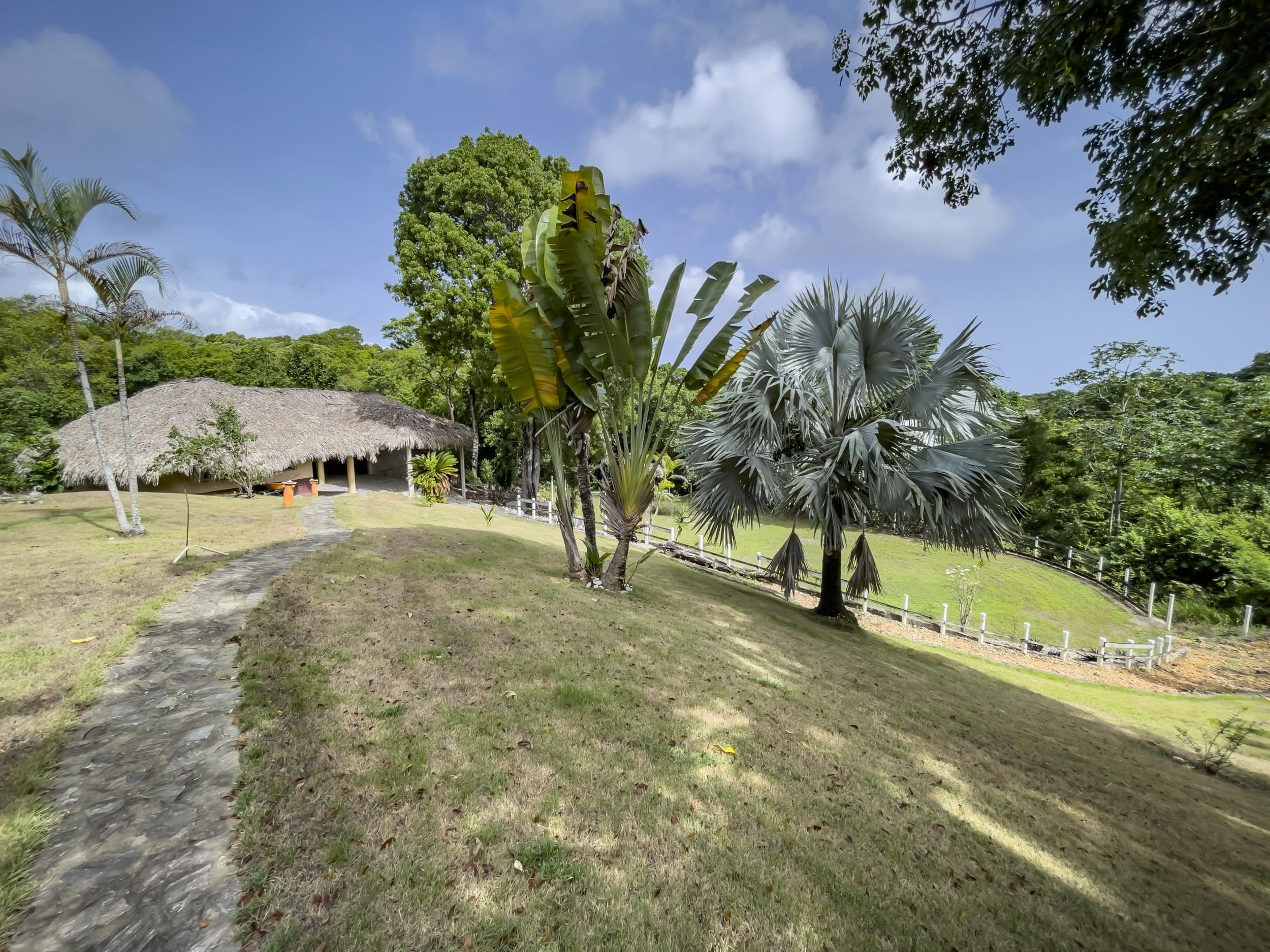 buyDRproperty Tropical landscape with thatched-roof building and building lot Sosua Real Estate