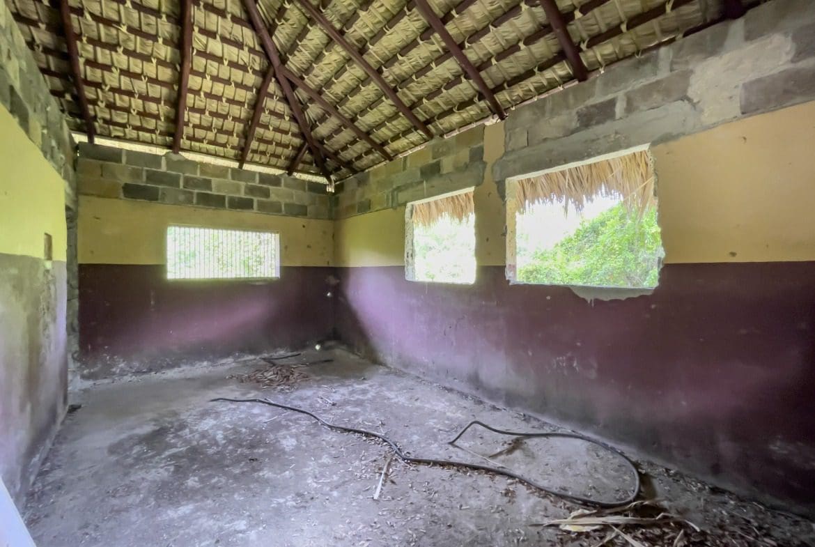 buyDRproperty Dilapidated building interior with thatch roof and building lot potential. Sosua Real Estate
