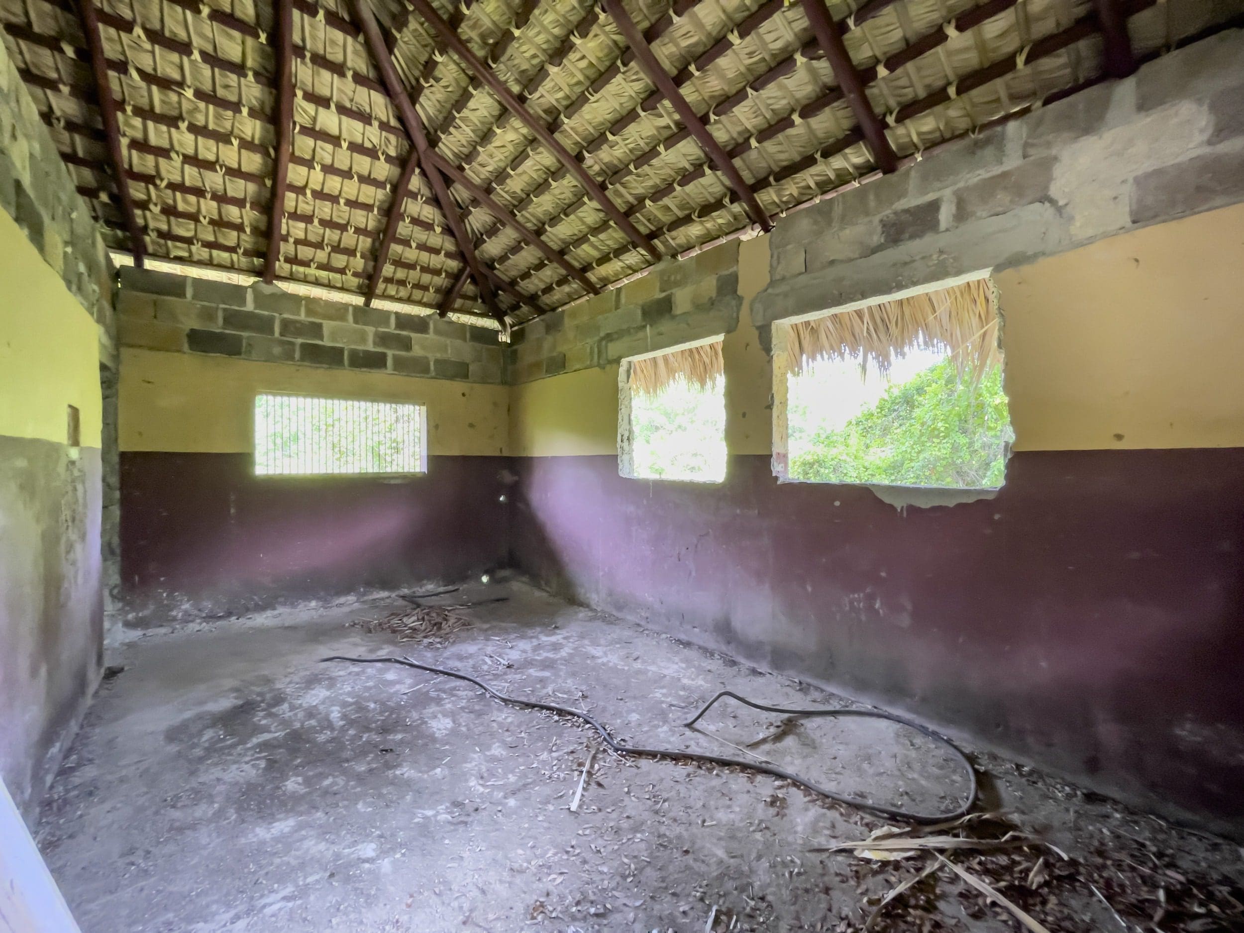 buyDRproperty Dilapidated building interior with thatch roof and building lot potential. Sosua Real Estate