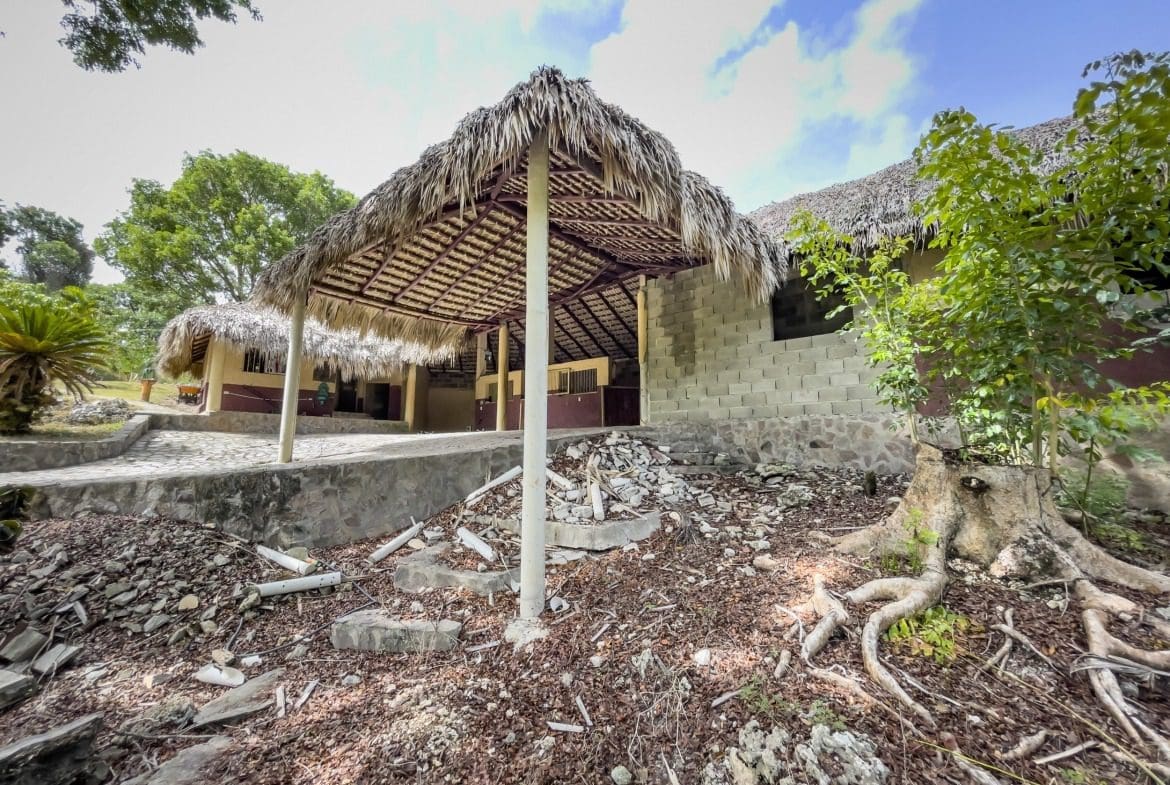 buyDRproperty Thatch-roofed building on a building lot, with potential for stables remodel. Sosua Real Estate