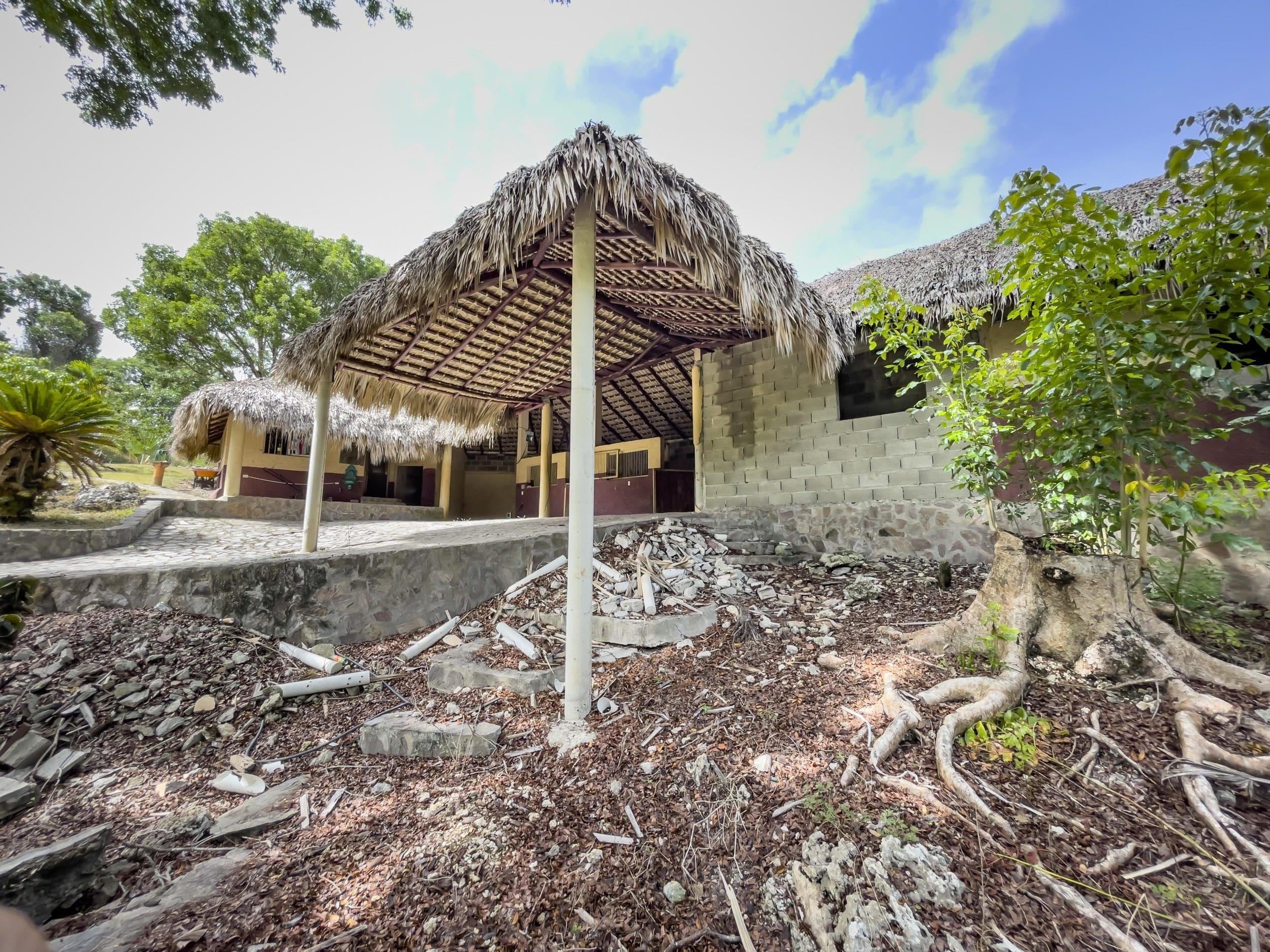 buyDRproperty Thatch-roofed building on a building lot, with potential for stables remodel. Sosua Real Estate