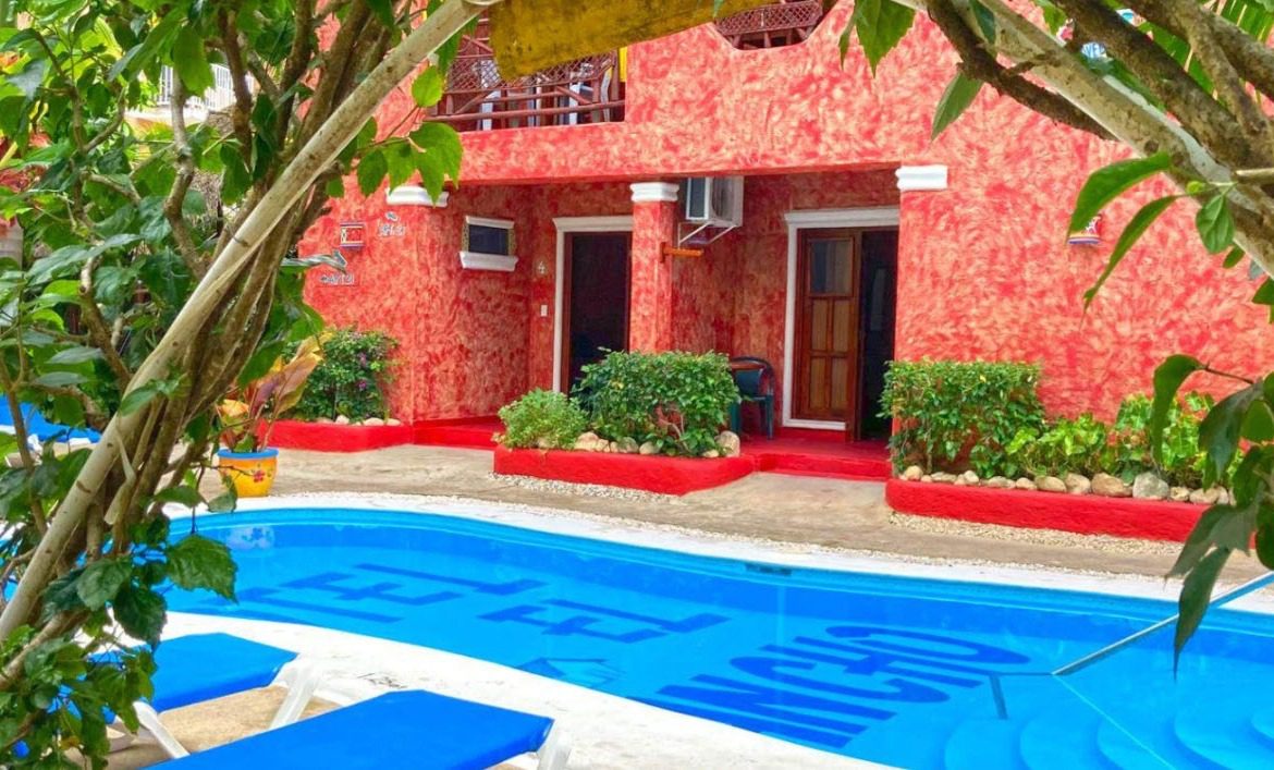 buyDRproperty Beach Hotel with pool. A vibrant red Hotel for sale. Sosua Real Estate