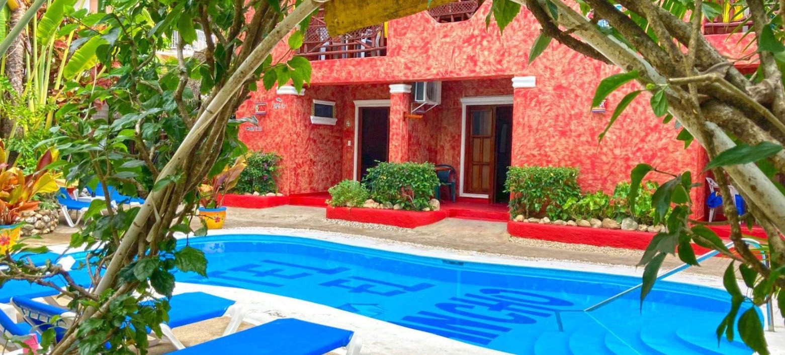 buyDRproperty Beach Hotel with pool. A vibrant red Hotel for sale. Sosua Real Estate