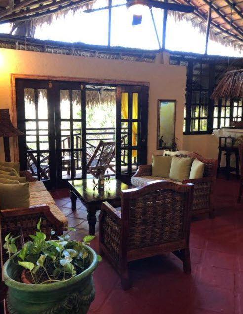 buyDRproperty Cozy seating area in Hotel with open doors to balcony Sosua Real Estate