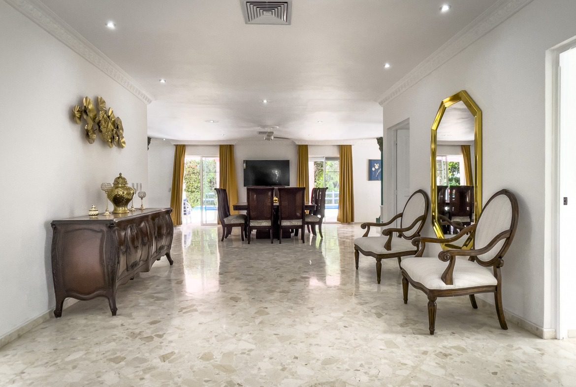 buyDRproperty Elegant villa interior with marble floor, ornate furniture, and dining area, a prime property. Sosua Real Estate