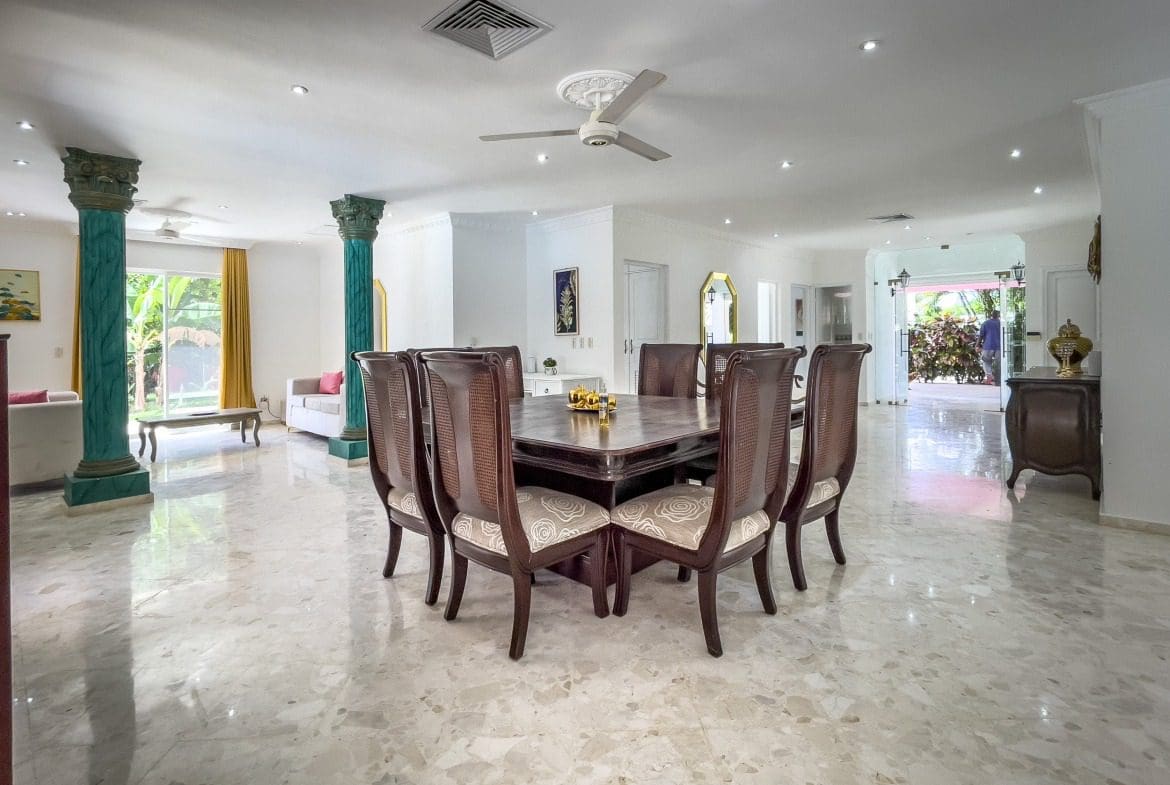 buyDRproperty Spacious dining area in a prime villa for sale, featuring a large table and chairs. Sosua Real Estate