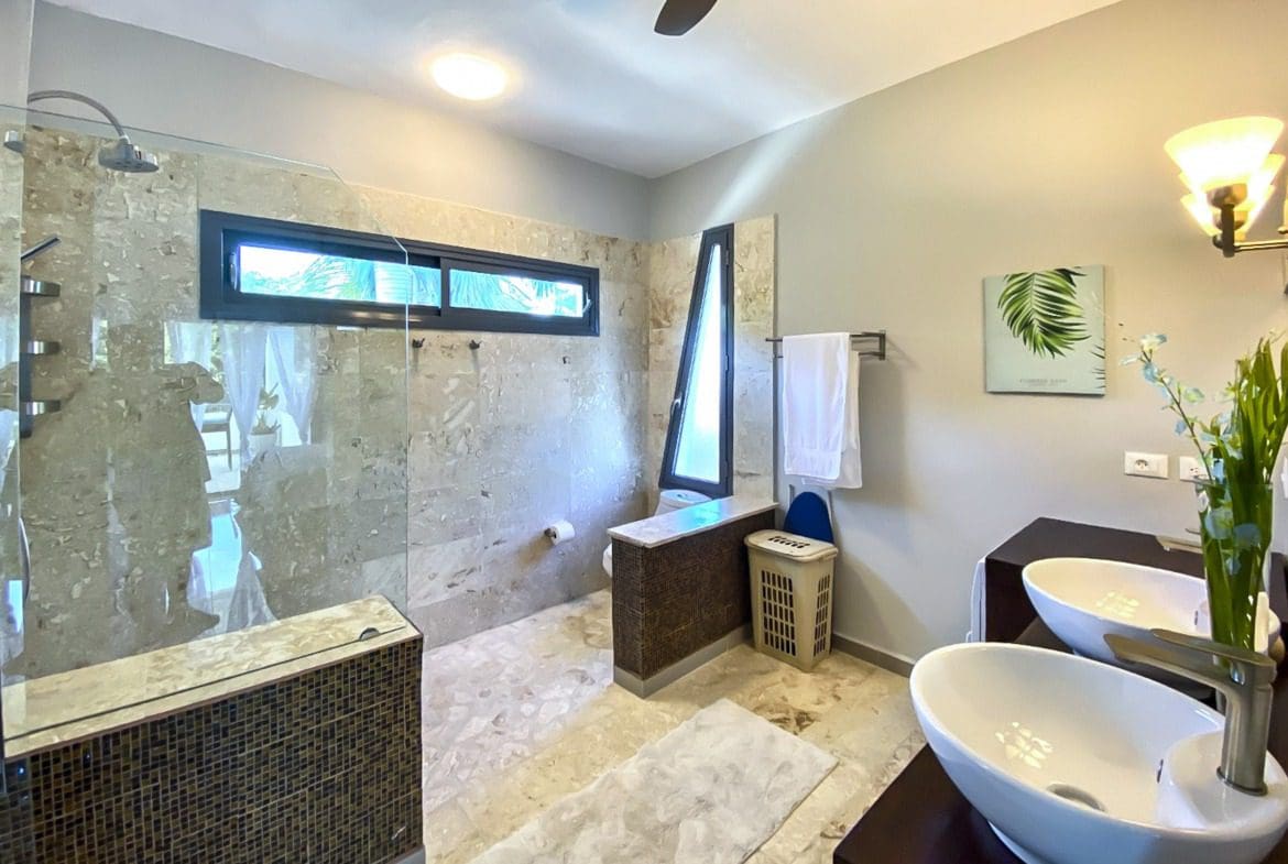 buyDRproperty Modern bathroom with walk-in shower, vessel sinks, and unique tile design. Sosua Real Estate