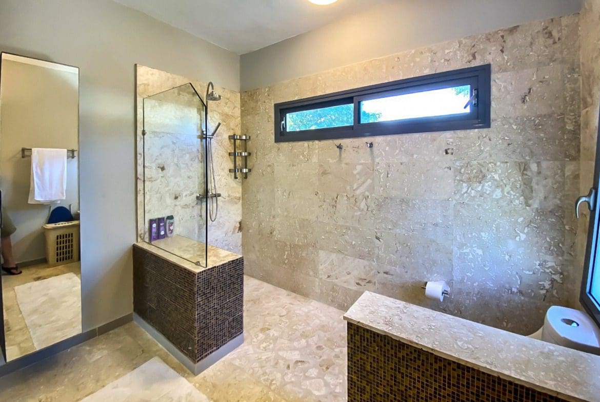 buyDRproperty Luxurious bathroom with walk-in shower and stone tile. Sosua Real Estate