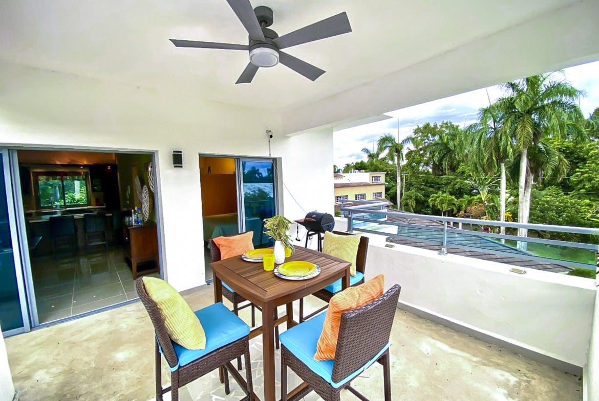 buyDRproperty Outdoor dining area on the balcony of a 2-bedroom penthouse for sale in ProCab. Sosua Real Estate