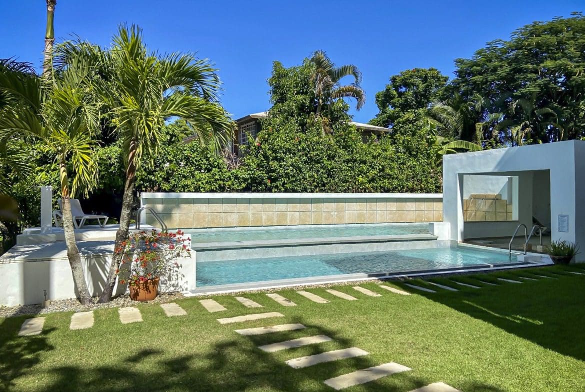 buyDRproperty Luxurious pool area in a tropical setting, perfect for a ProCab penthouse. Sosua Real Estate