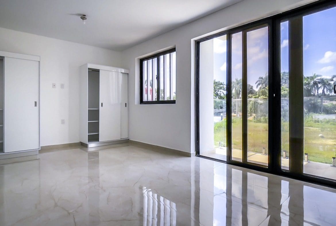 buyDRproperty Bright, modern 2 bedroom condo in Perla Marina with large windows and sliding doors. Sosua Real Estate