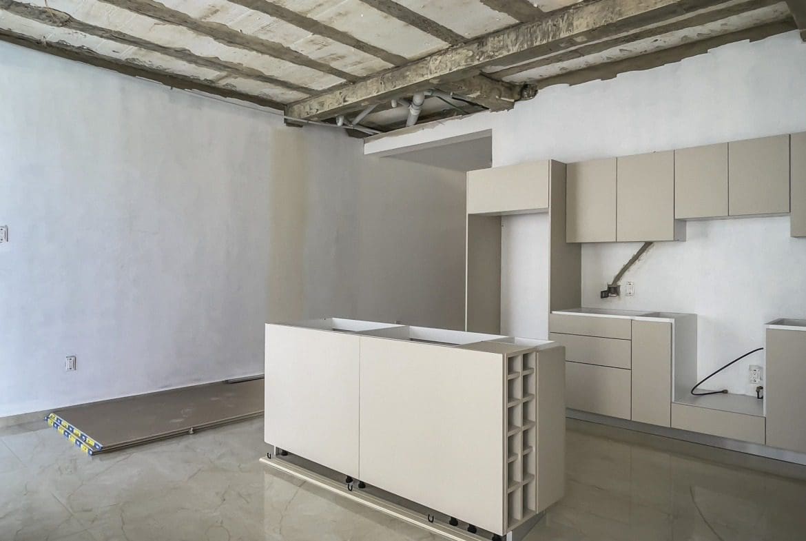 buyDRproperty Modern kitchen under construction with cabinetry and island Sosua Real Estate