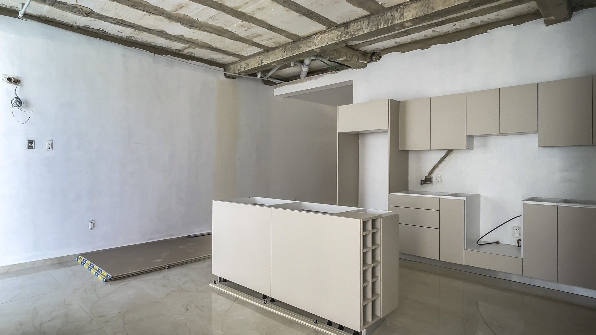 buyDRproperty Modern kitchen under construction with cabinetry and island Sosua Real Estate