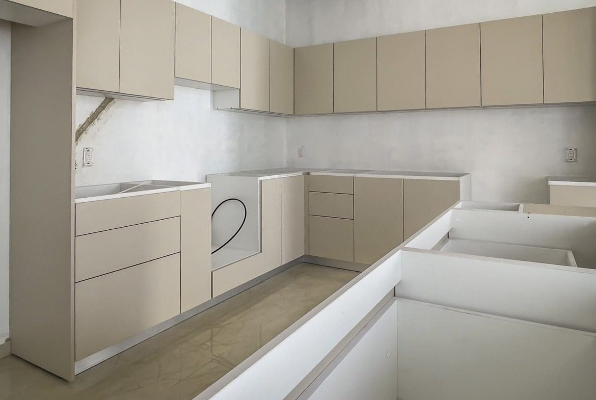 buyDRproperty Modern kitchen with beige cabinets and countertops. Under construction. Sosua Real Estate