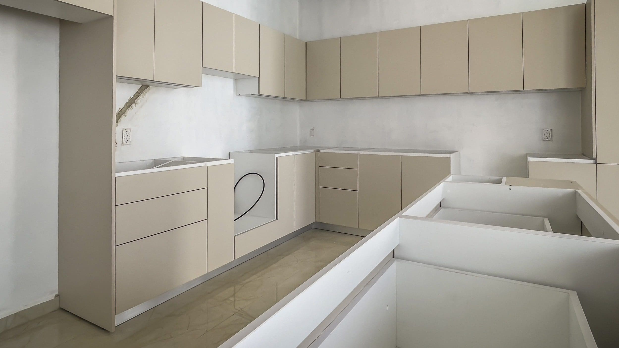 buyDRproperty Modern kitchen with beige cabinets and countertops. Under construction. Sosua Real Estate