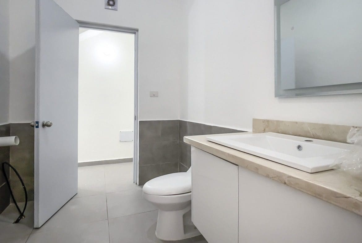 buyDRproperty Modern bathroom with white sink and toilet. For Sale! Perla Marina Condo. Sosua Real Estate