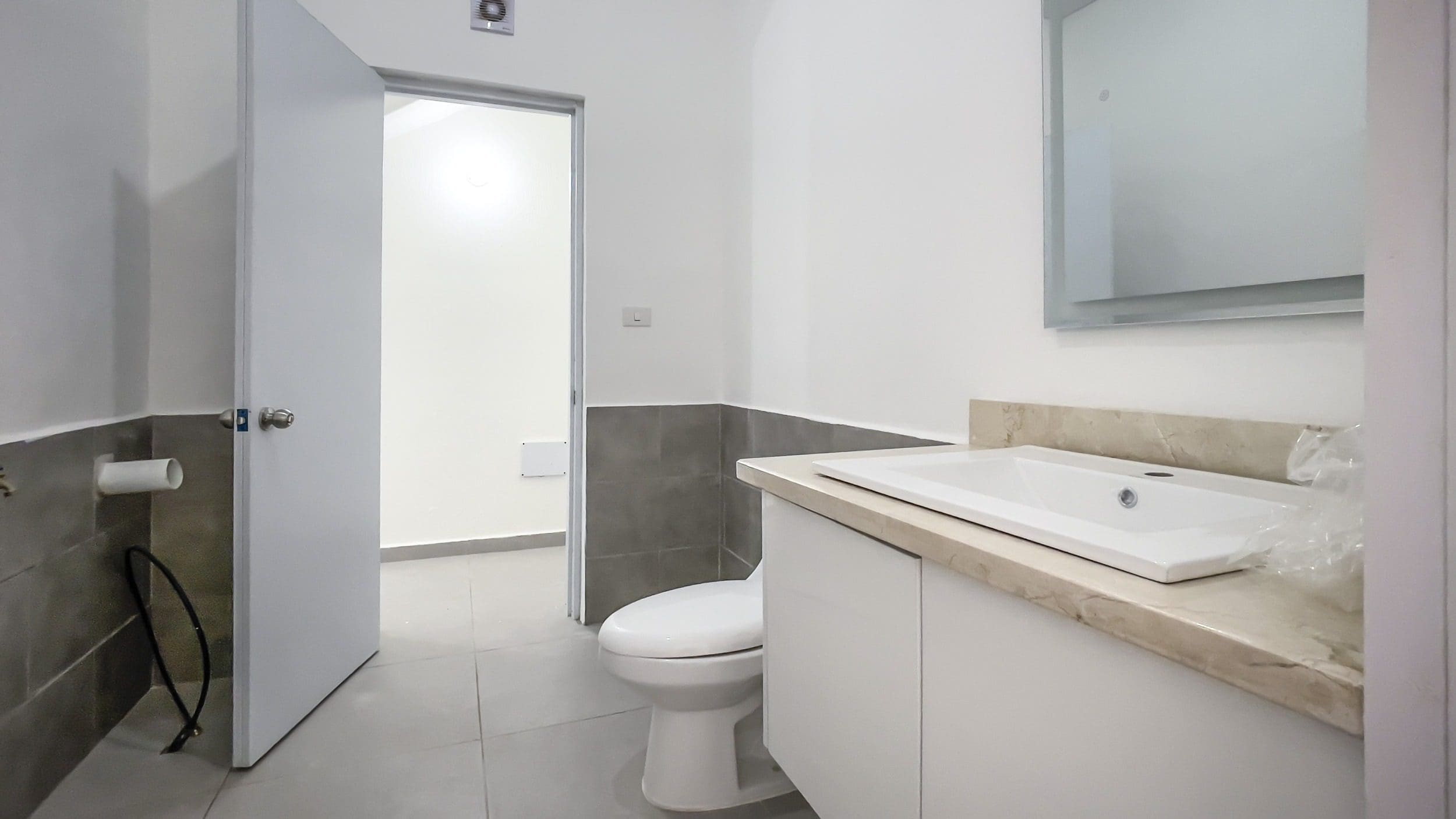 buyDRproperty Modern bathroom with white sink and toilet. For Sale! Perla Marina Condo. Sosua Real Estate