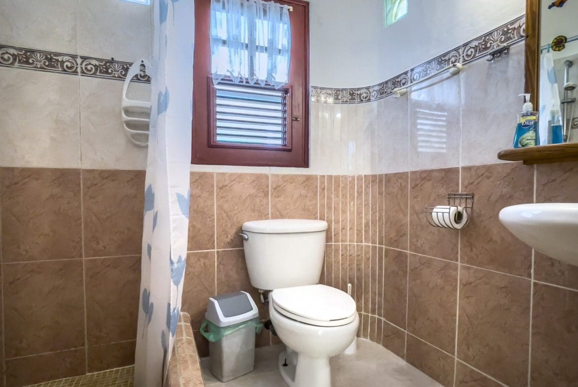 buyDRproperty Bathroom in a charming B&B with window and toilet. Sosua Real Estate