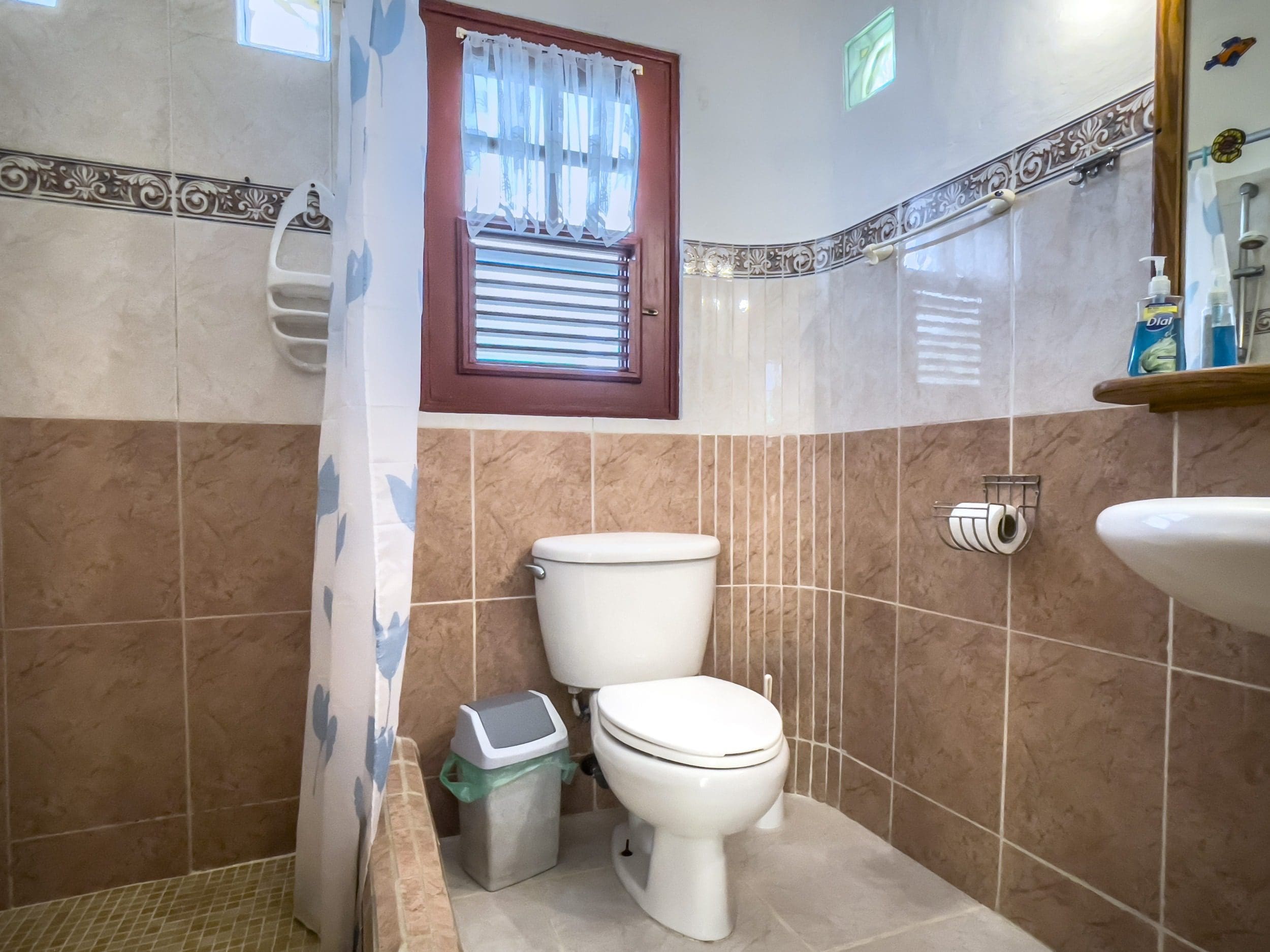 buyDRproperty Bathroom in a charming B&B with window and toilet. Sosua Real Estate