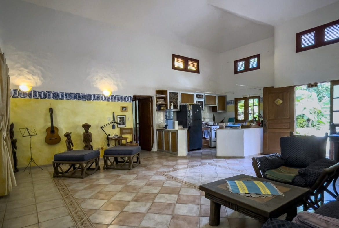 buyDRproperty Charming B&B living room with kitchen area and decorative items. Sosua Real Estate