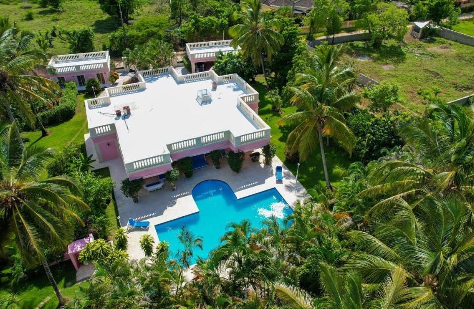 buyDRproperty Aerial view of a prime villa with a pool surrounded by lush greenery Sosua Real Estate