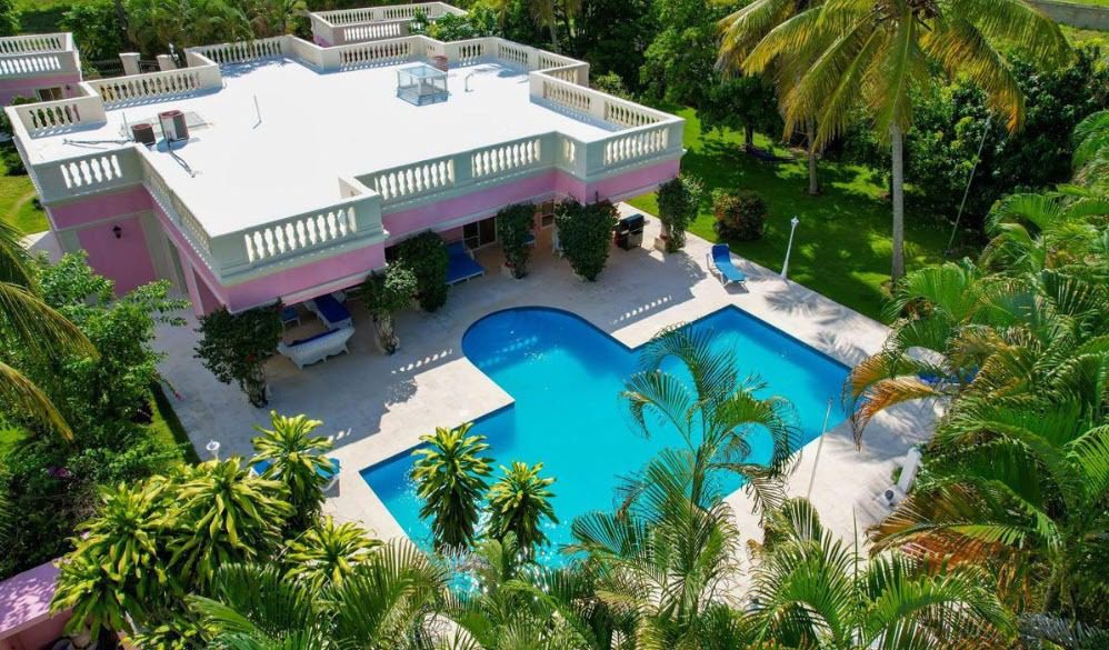 buyDRproperty Prime villa for sale near the beach with a pool and tropical landscaping. Sosua Real Estate