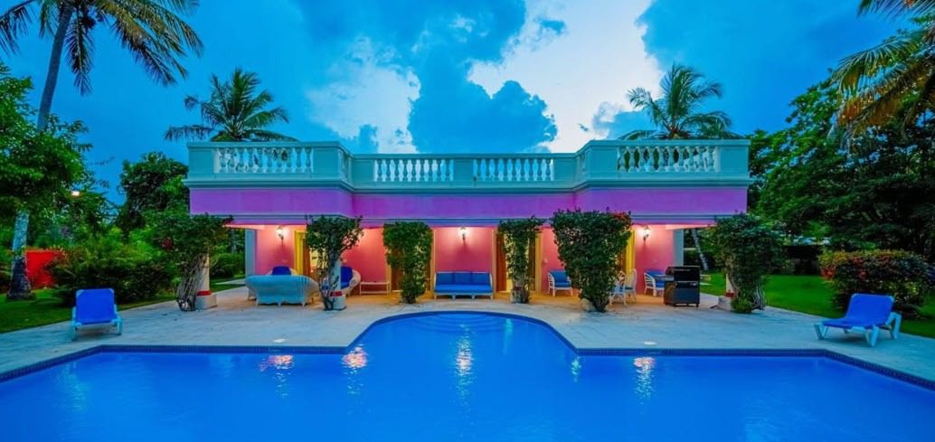 buyDRproperty Luxury prime villa with a pool, outdoor seating, and tropical surroundings. Sosua Real Estate