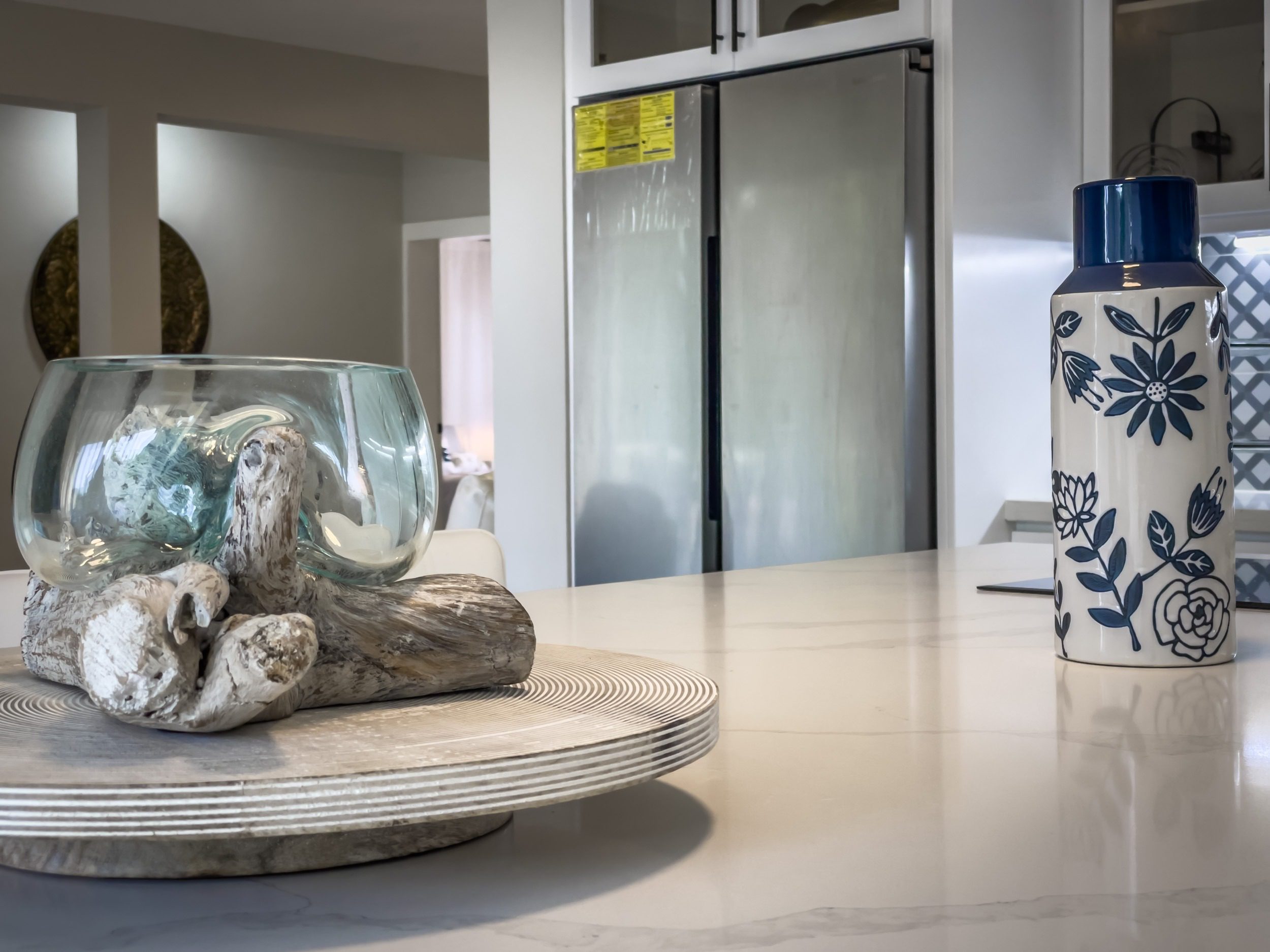 buyDRproperty Modern kitchen countertop with decorative glass bowl and floral vase, offering modern comfort. Sosua Real Estate