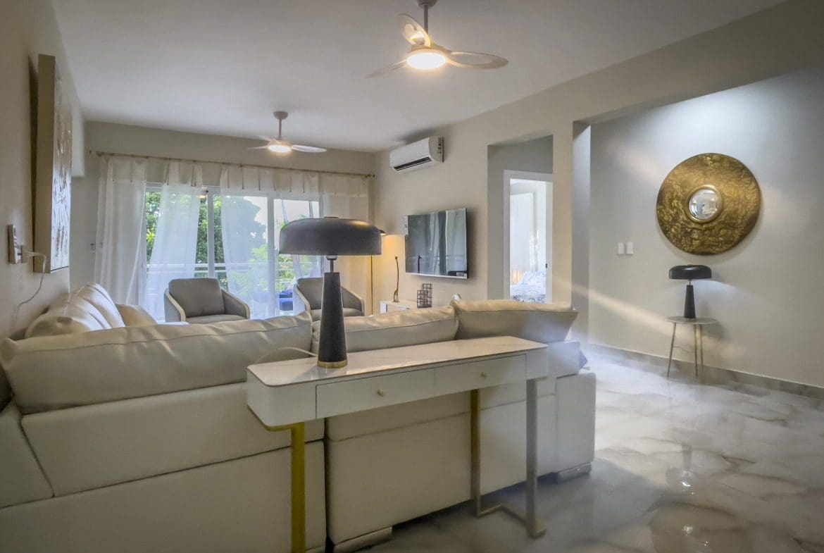 buyDRproperty Modern living room with white sofa and stylish decor, offering modern comfort. Sosua Real Estate