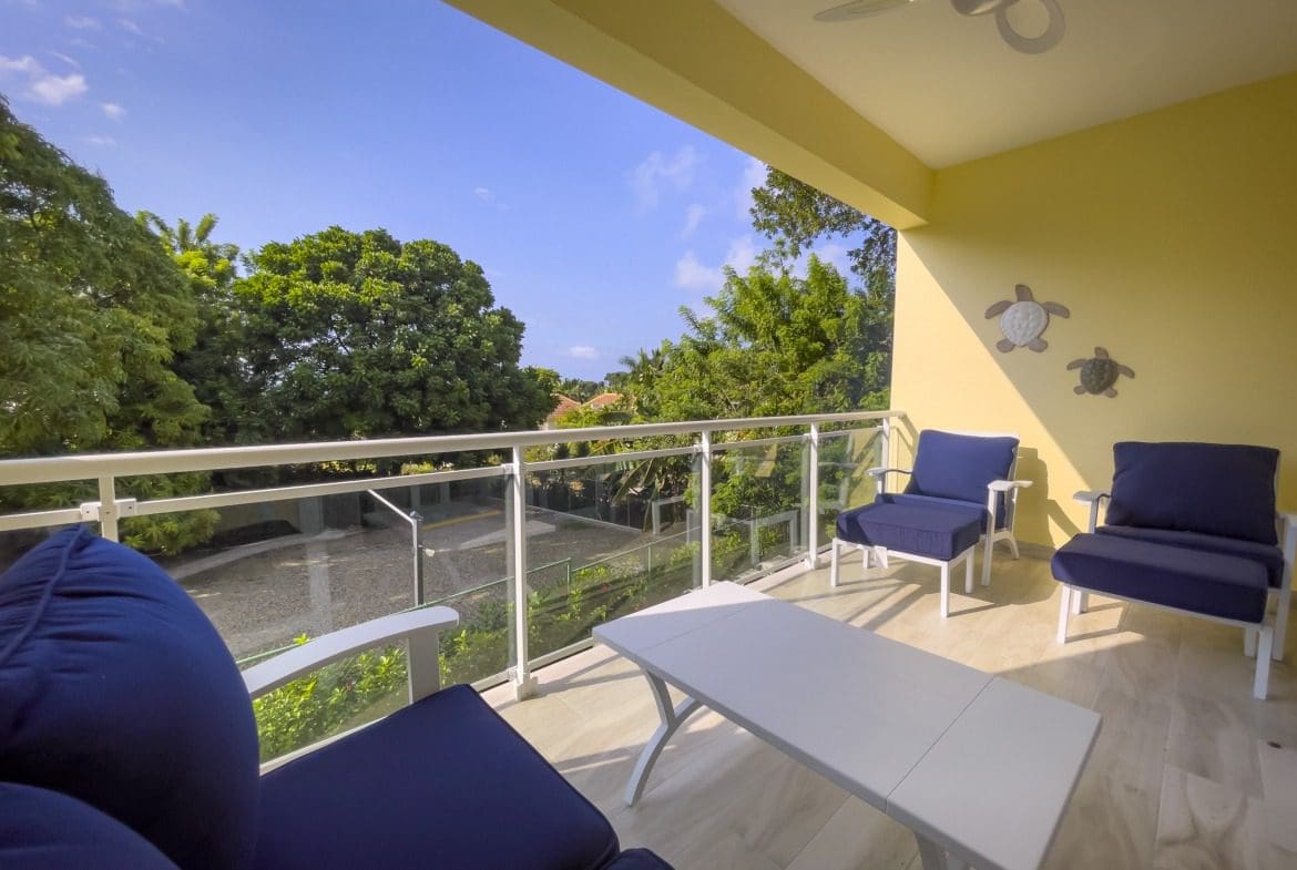 buyDRproperty Balcony with blue chairs and white table offers modern comfort with a view. Sosua Real Estate