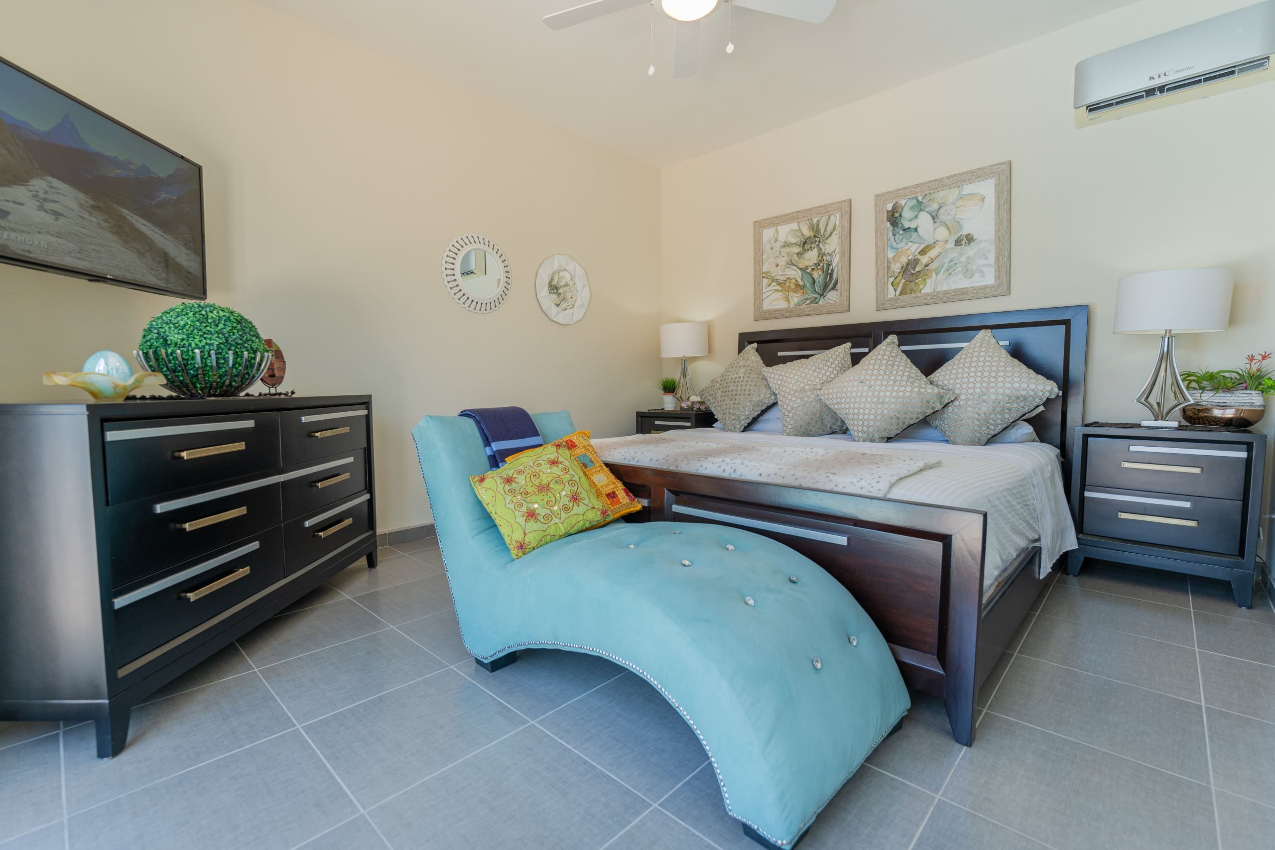buyDRproperty Bedroom in a 5 BR Luxury Villa. Features a chaise lounge and dark wood furniture. Sosua Real Estate