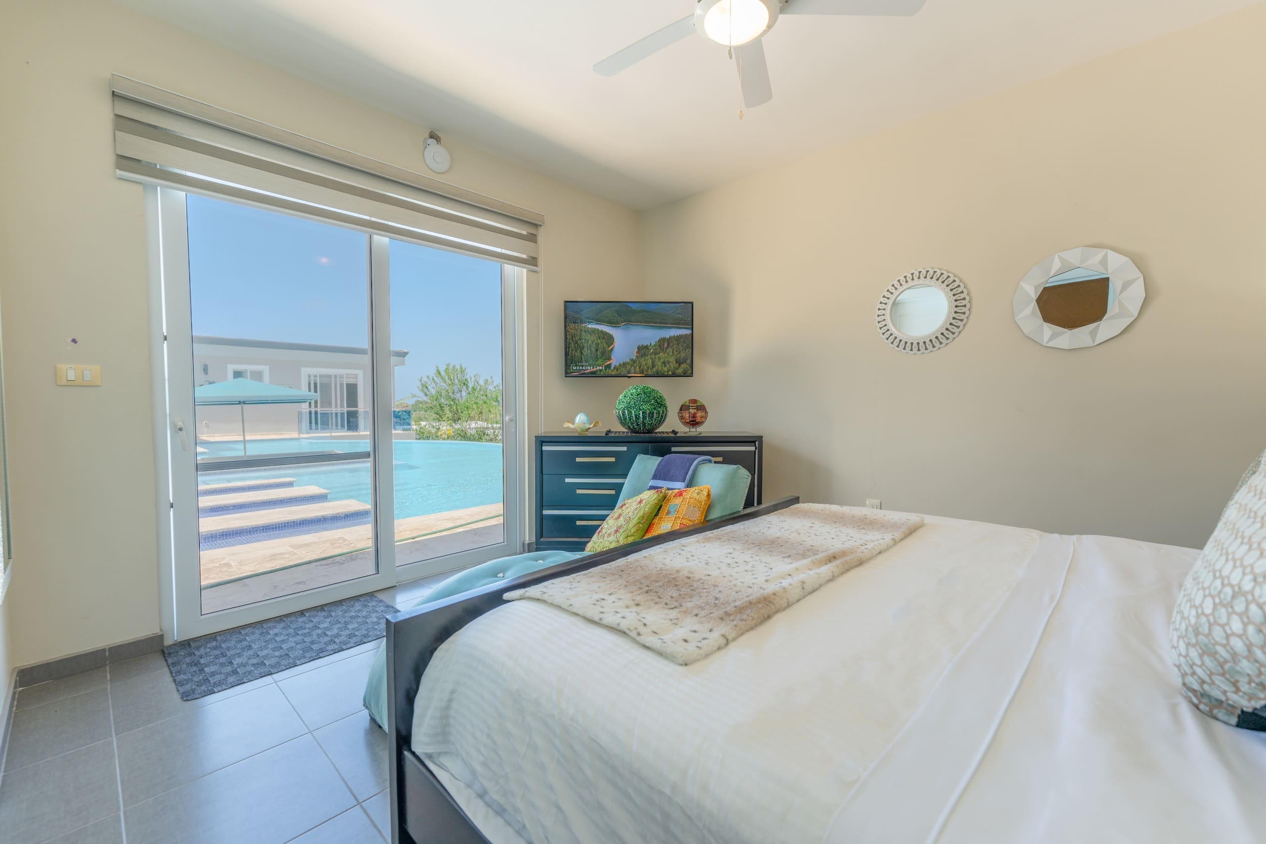 buyDRproperty Bedroom in a 5 BR Luxury Villa with pool view and modern decor. Sosua Real Estate