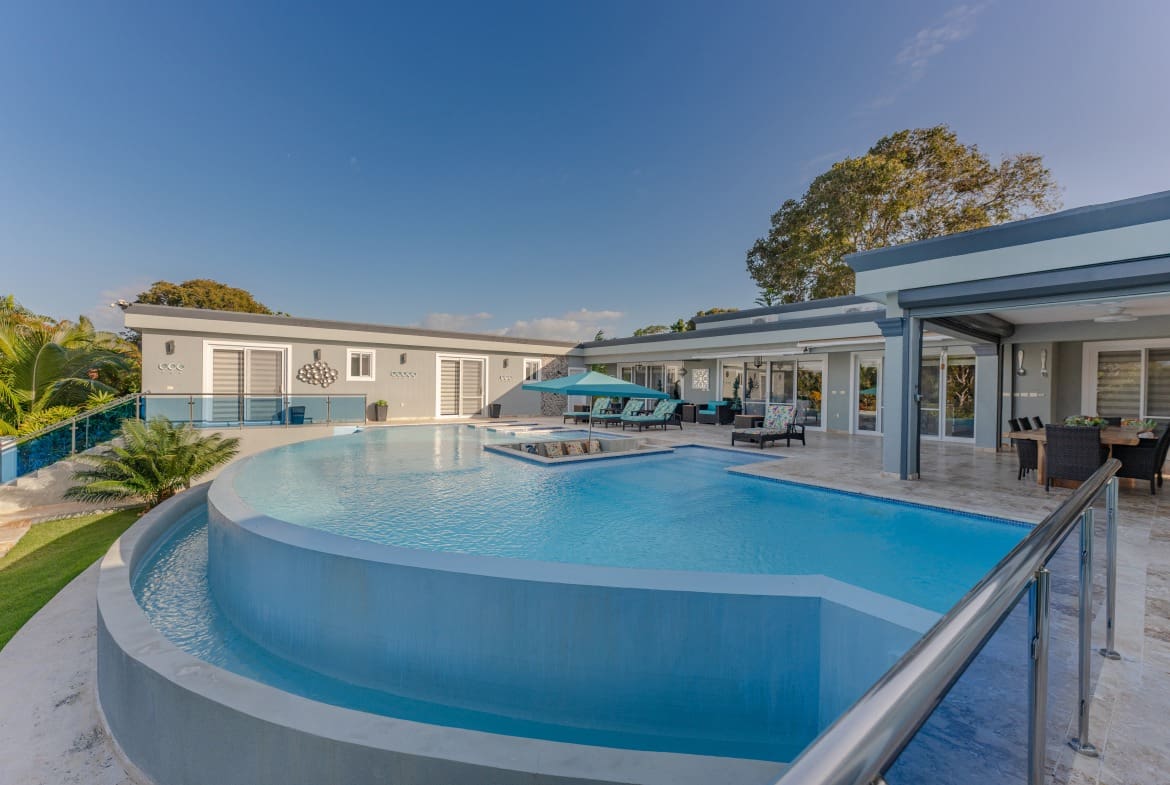 buyDRproperty Luxury 5 BR villa with a large pool and outdoor dining area. Sosua Real Estate