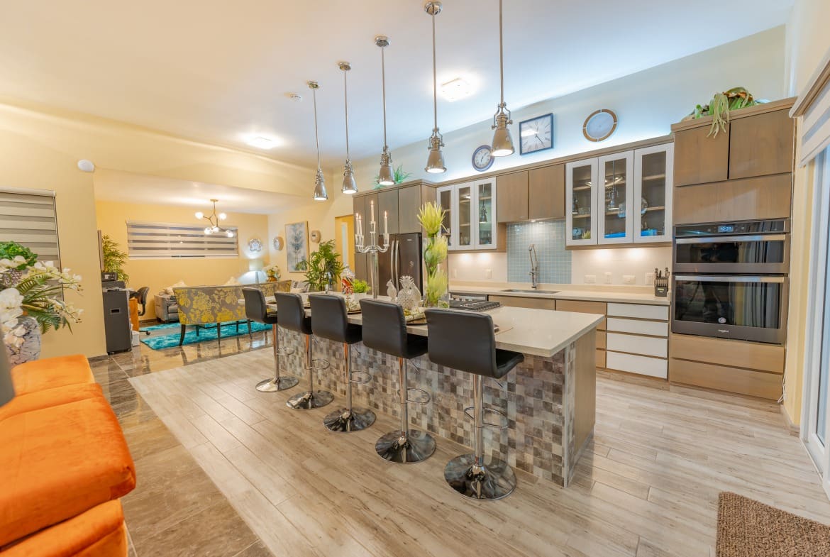 buyDRproperty Luxury kitchen in a 5 BR Luxury Villa with island and bar stools Sosua Real Estate