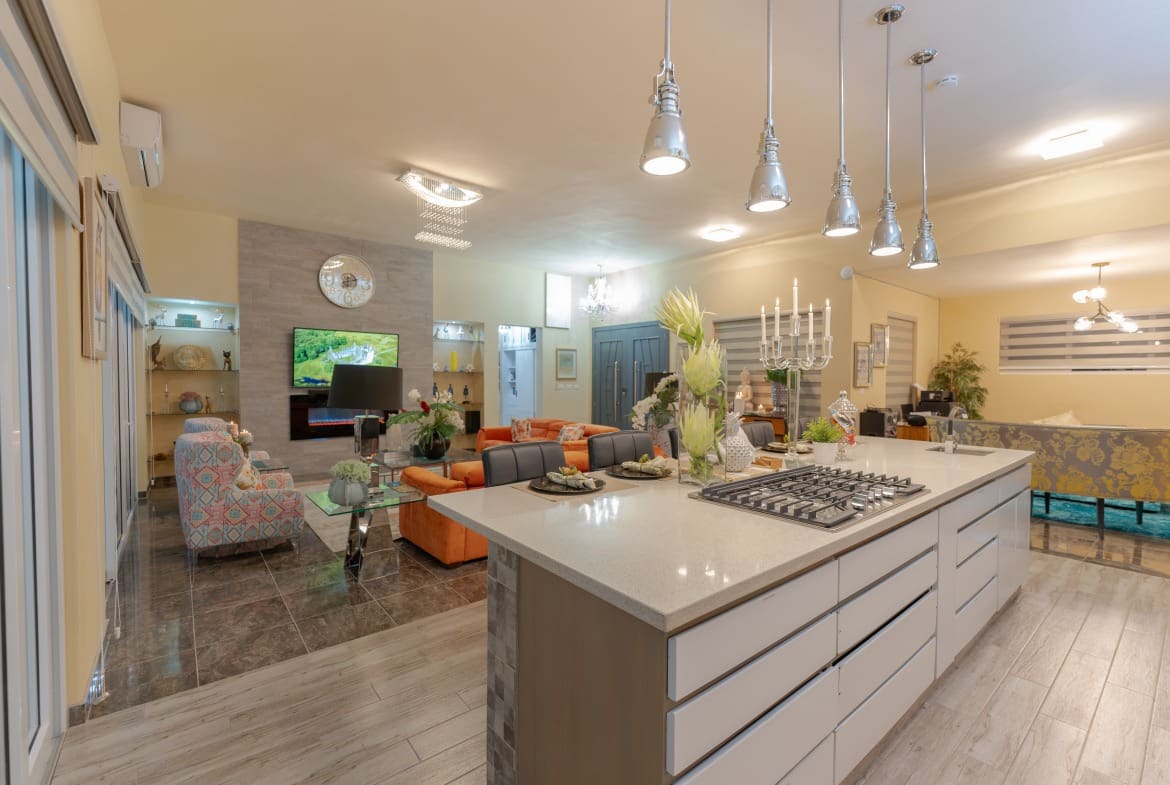 buyDRproperty Luxury kitchen in a 5 BR luxury villa. Modern island with stovetop and pendant lights. Sosua Real Estate