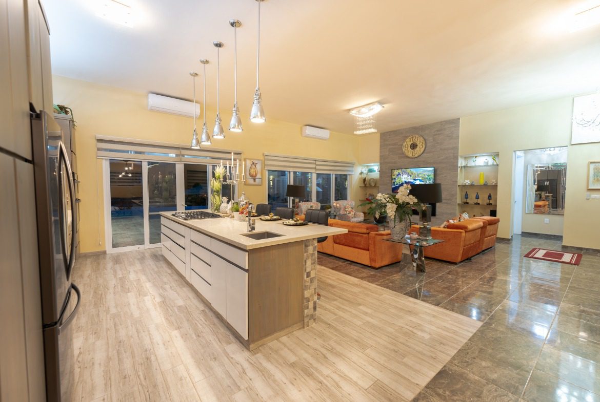 buyDRproperty Luxury 5 BR Villa interior with open kitchen and living area. Sosua Real Estate