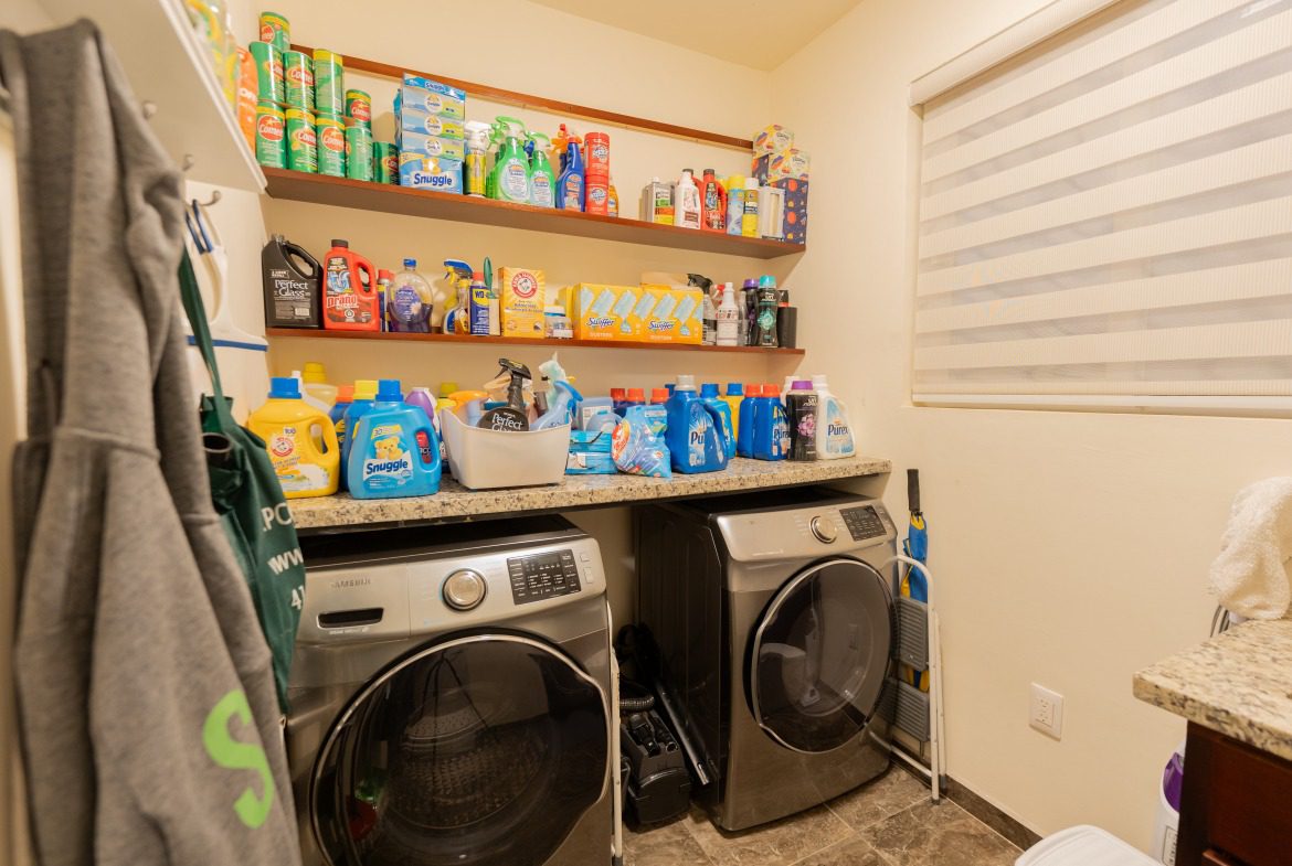 buyDRproperty Laundry room with washing machine and shelves of cleaning supplies. Sosua Real Estate