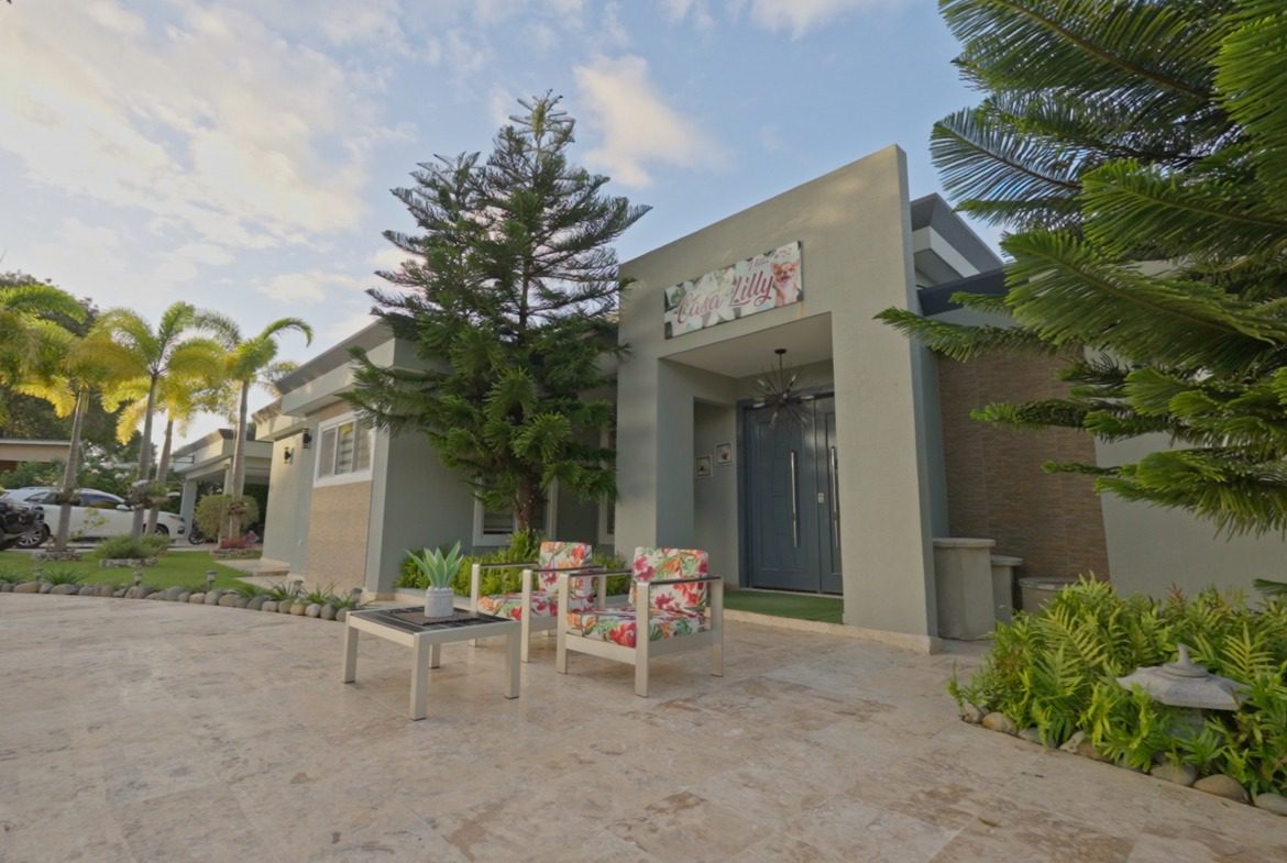 buyDRproperty Casa Lilly 5 BR luxury villa exterior with seating area Sosua Real Estate