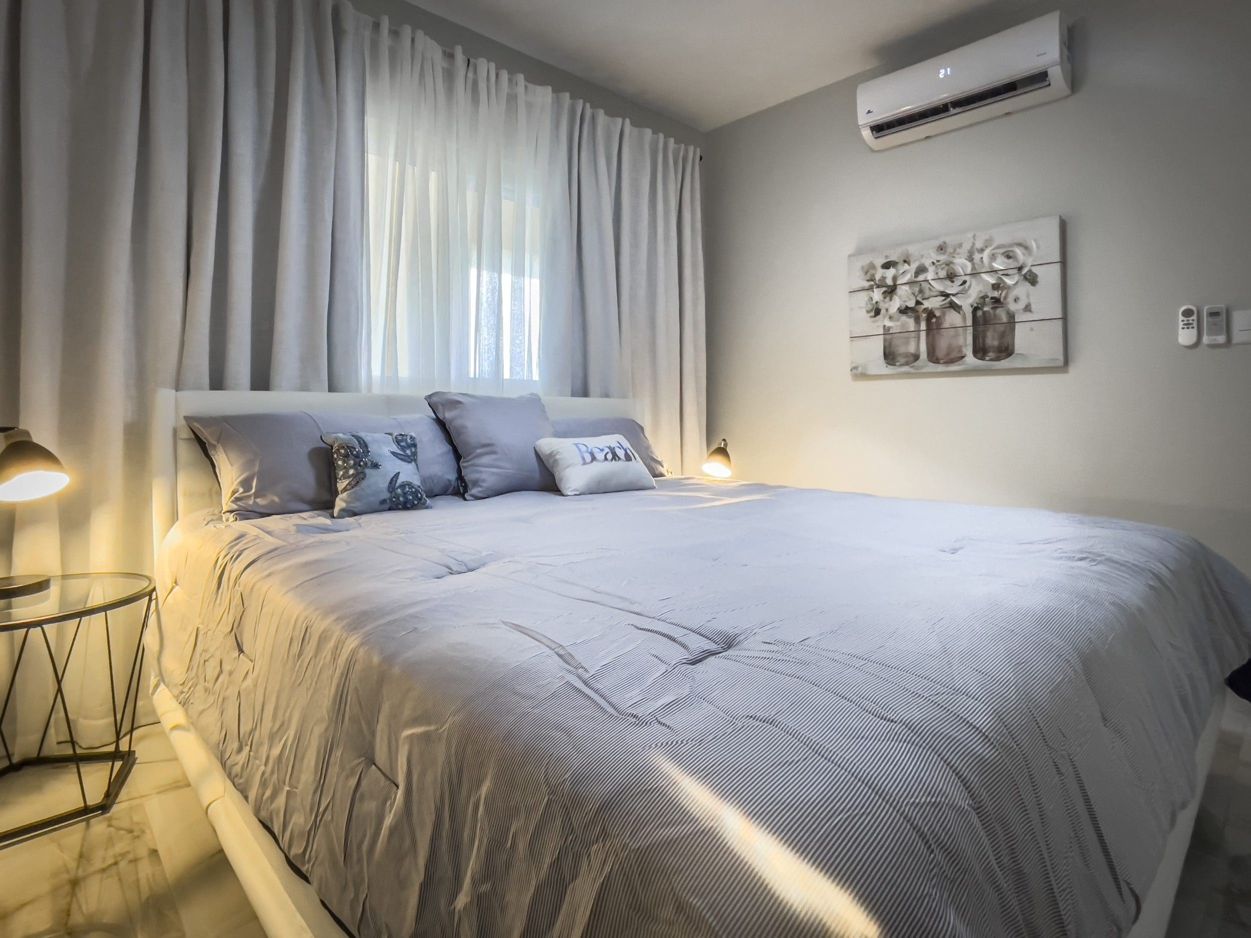 buyDRproperty Bedroom in a 1-bedroom condo with a comfortable bed and stylish decor. Sosua Real Estate