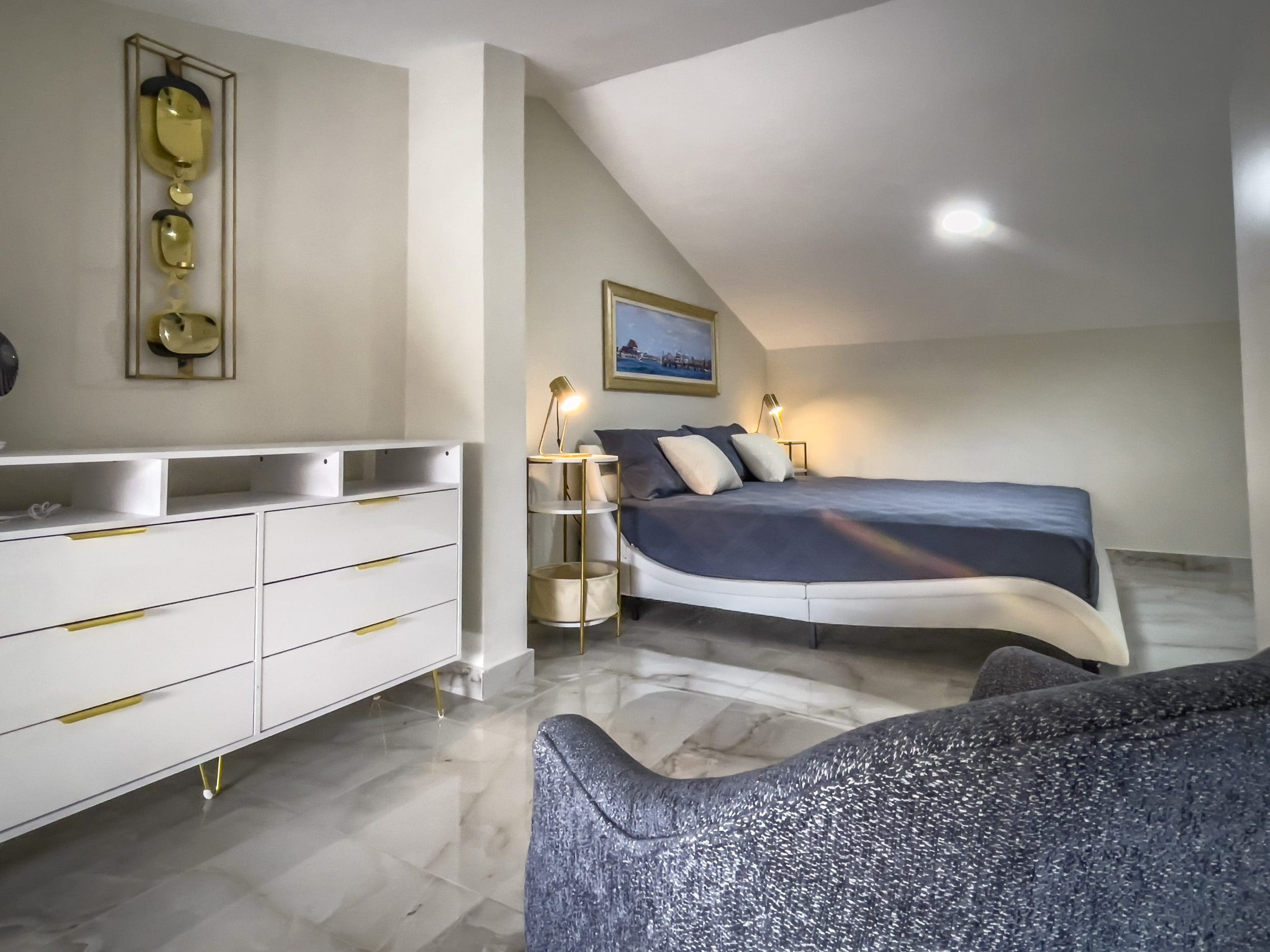 buyDRproperty Modern 1-bedroom condo loft bedroom with stylish decor and bed Sosua Real Estate